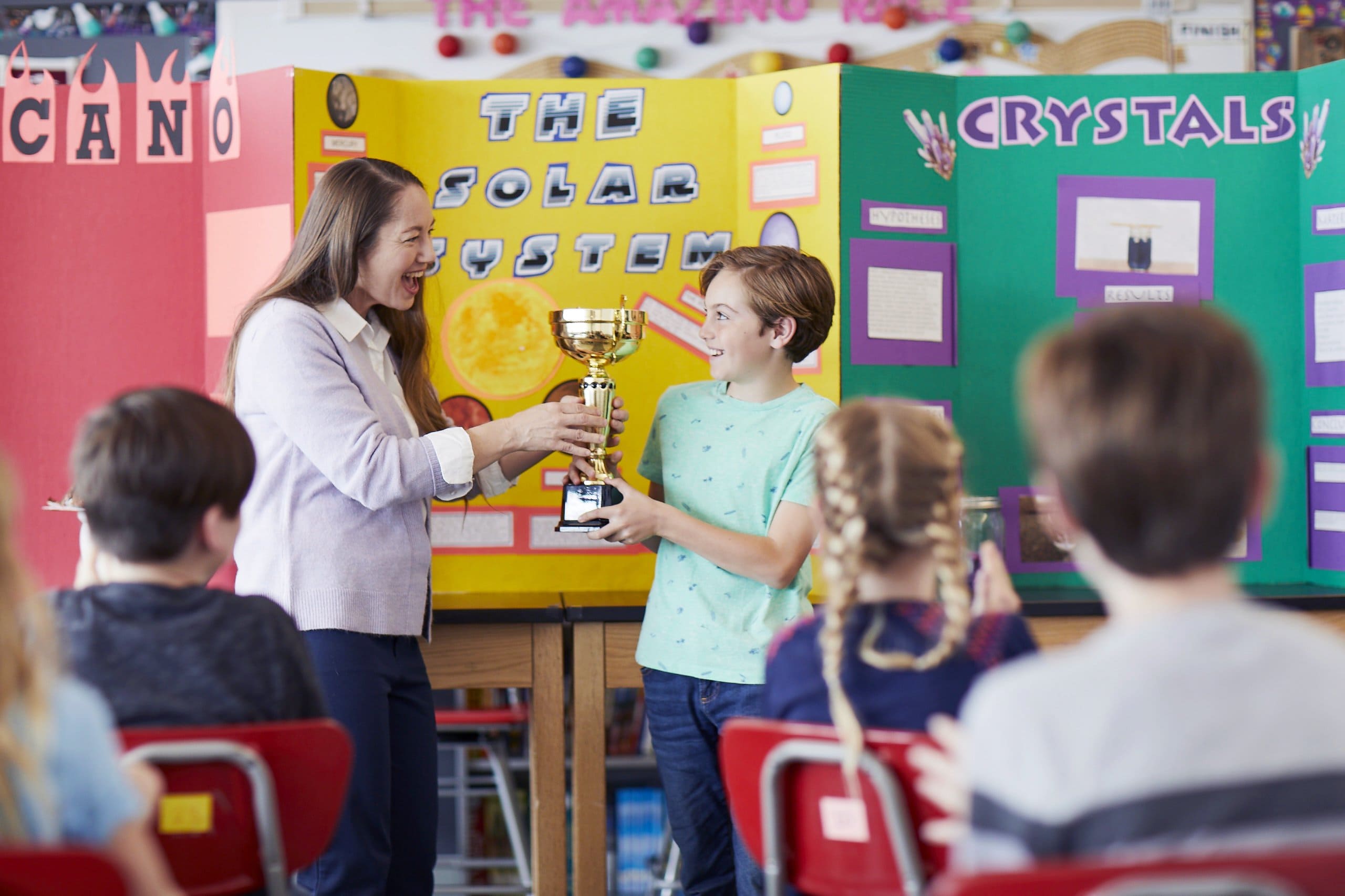Student receiving a trophy for math achievements