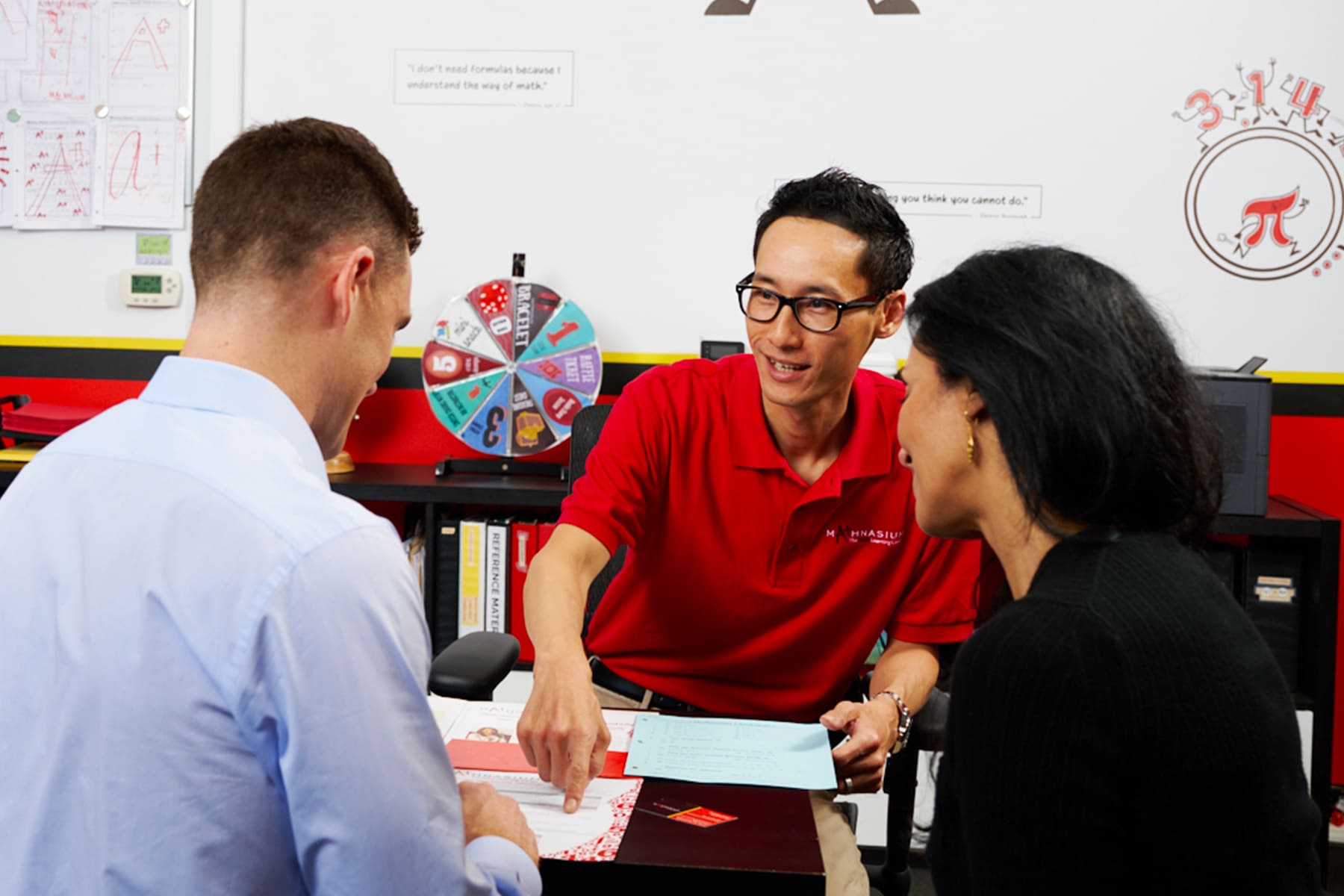 Math tutor presenting a personalized learning plan to student and his parents