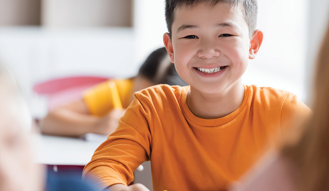 A boy smiling in class