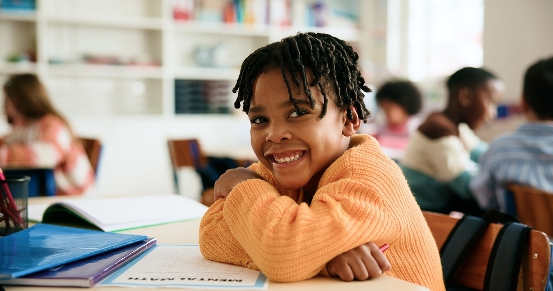 A confident-looking student smiling during math class