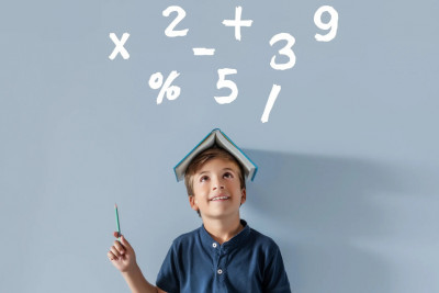 A boy, pencil in hand, looks up at a number sign, reflecting interest in numbers or learning activities.